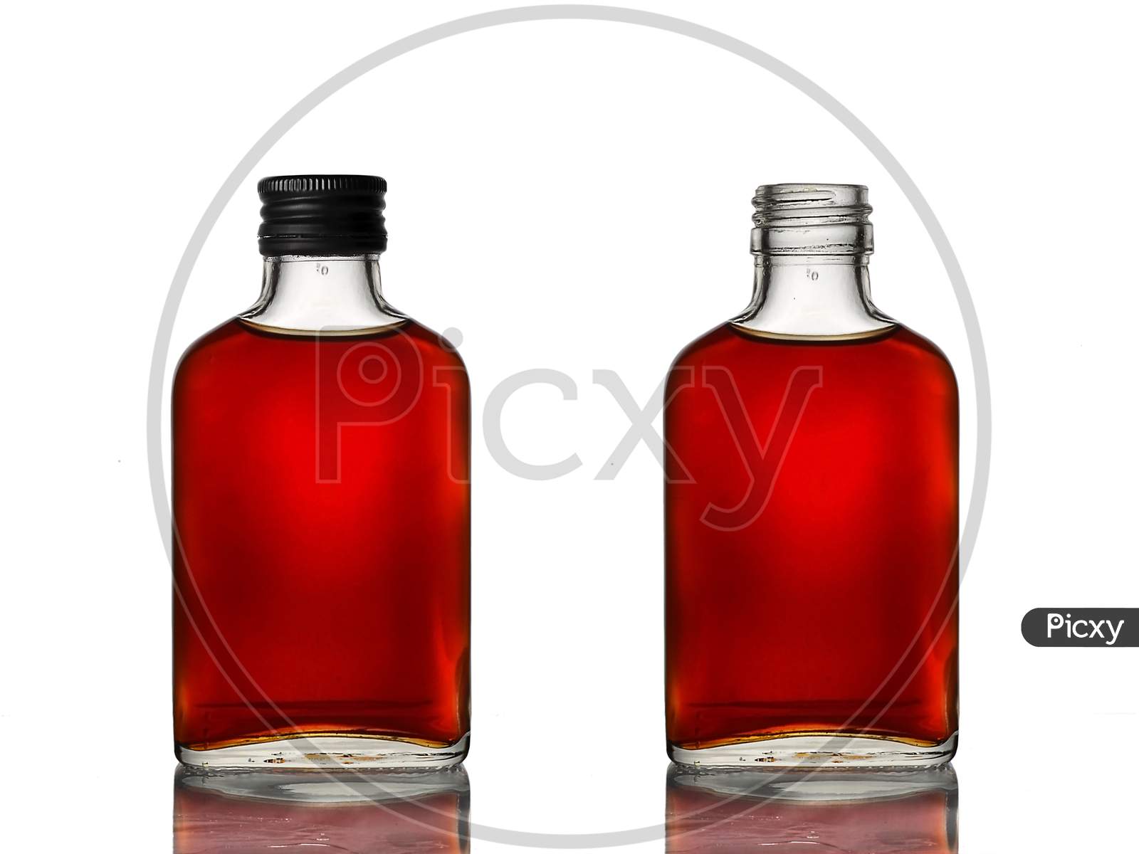 Mini glass bottles with brown beverage