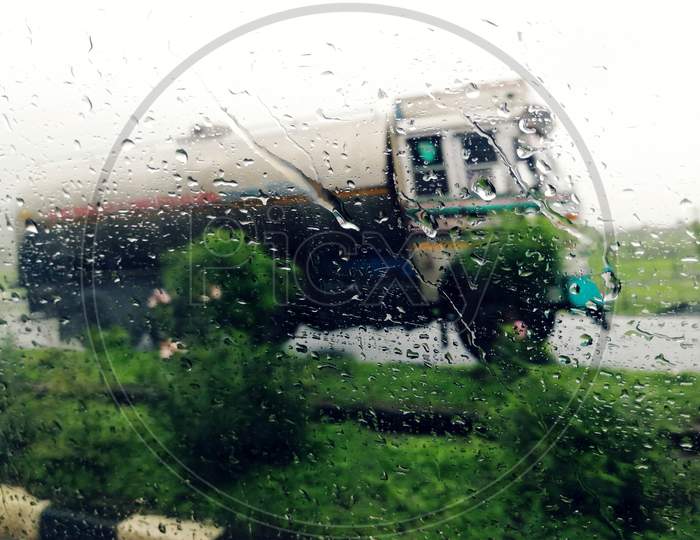 auto part,tree,rain,rain drop,window,glass,vehicle