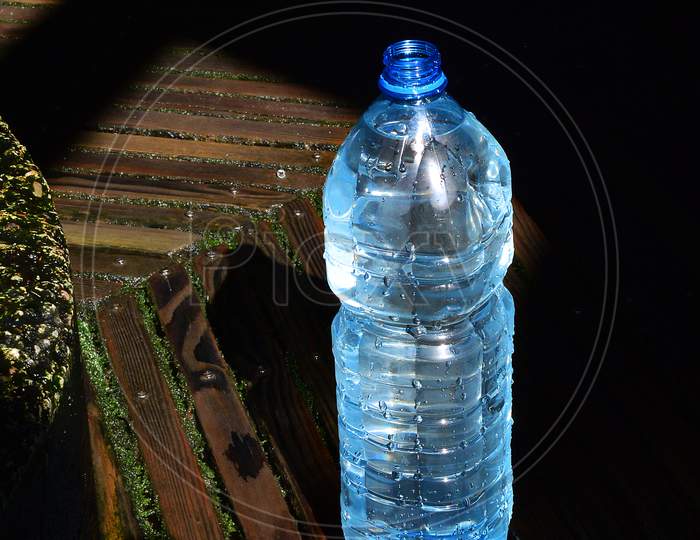 A plastic bottle with fresh water from an old well