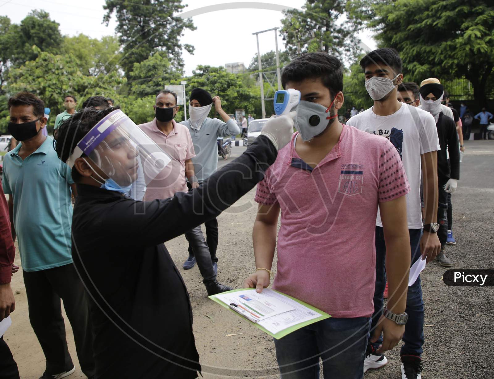 National Defence Academy (NDA) aspirants being screened as per COVID-19 protocol before allowing into an examination centre in Jammu August 6, 2020.
