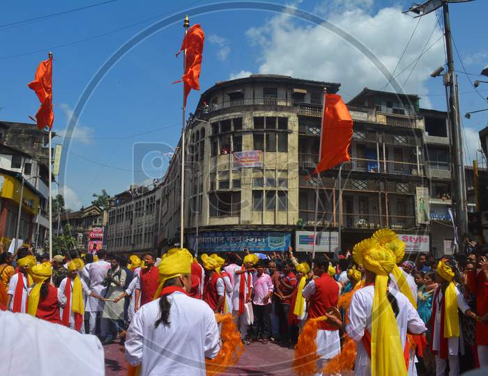 Pune, India - September 4, 2017: Dhol Tasha Pathak Dancing With Three Orange Flags Celebrating Ganapati Visarjan Festival. Dhol Tasha Pathak On Streets Of Pune With Orange Flags.