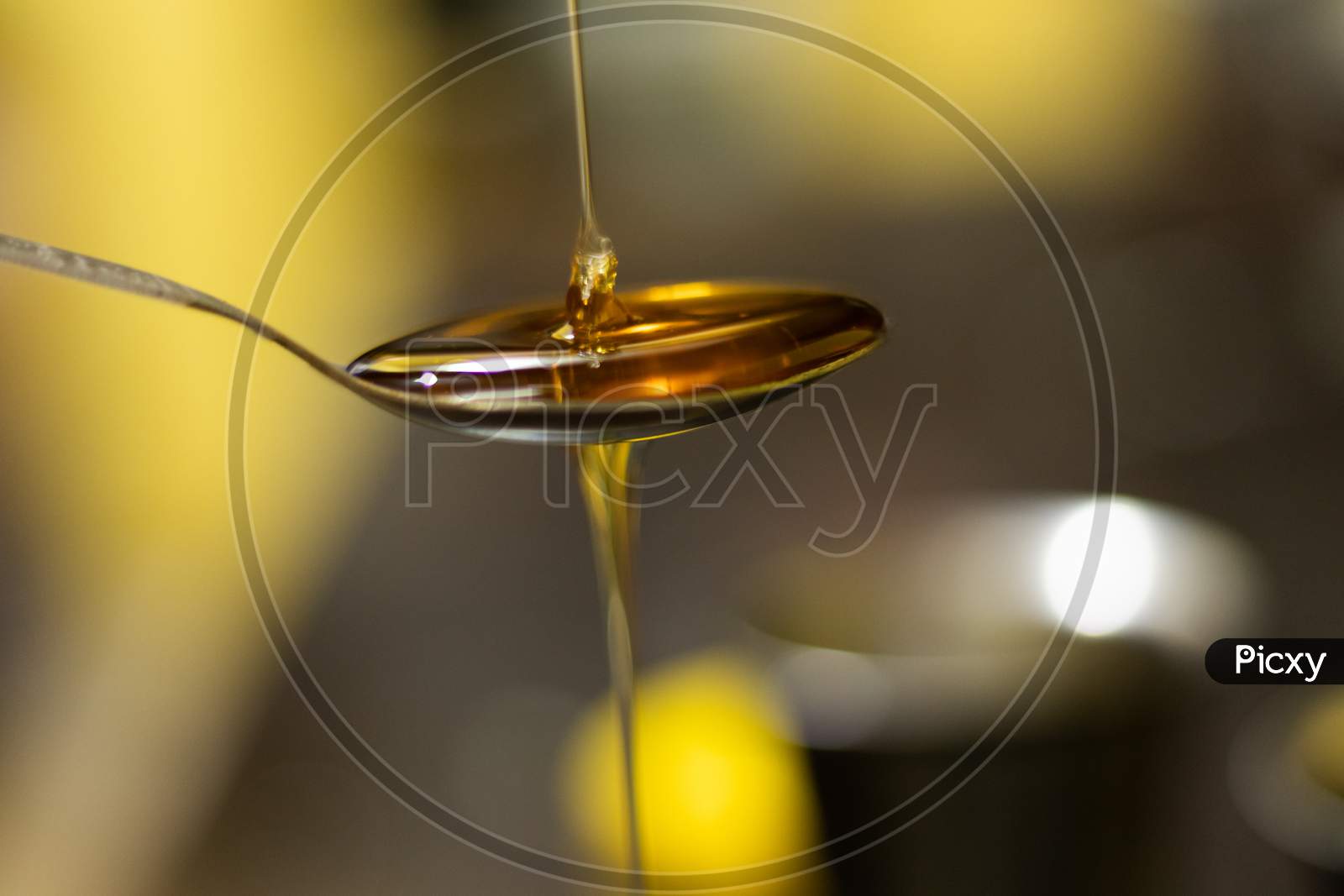 Honey dripping from a spoon