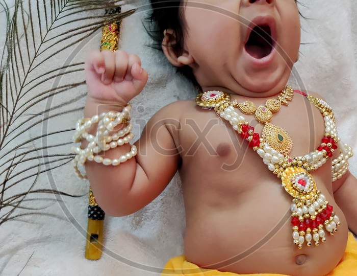 Little krishna gets tired and yawns