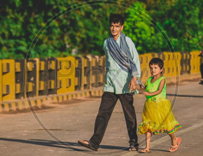 A father walking with his daughter