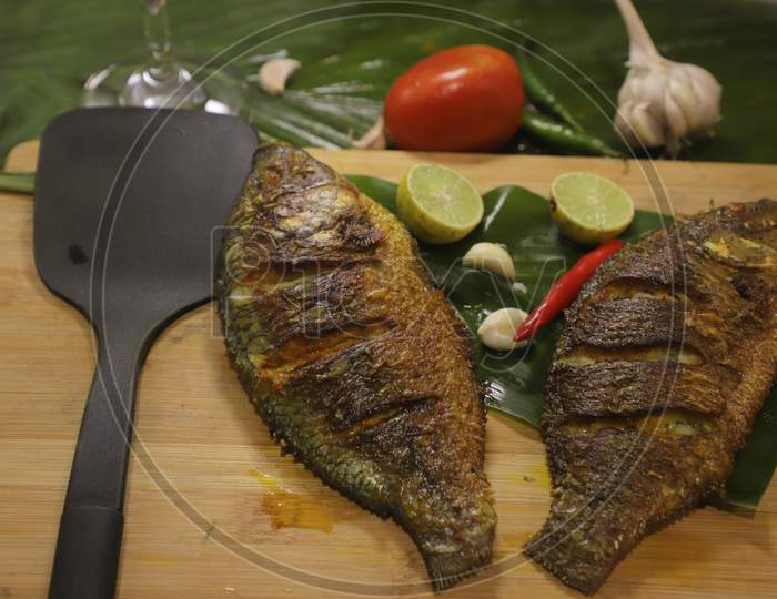 Tilapia fish. It's a shallow  fried fish. Considered as one of the low price and highly tasty fish.