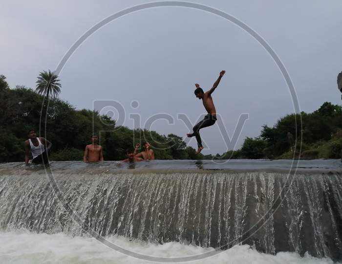 Indian guys bathing in Check dam