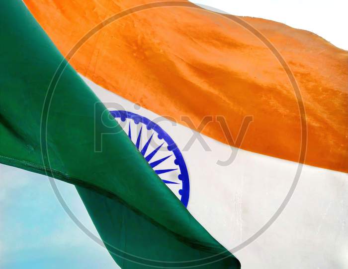 Indian flag waving against beautiful blue sky.