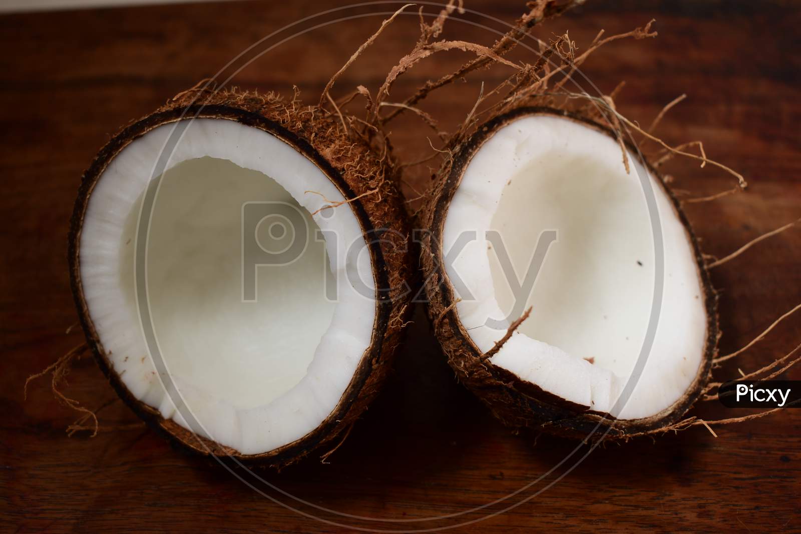 Pieces Of Coconut With Brown Background
