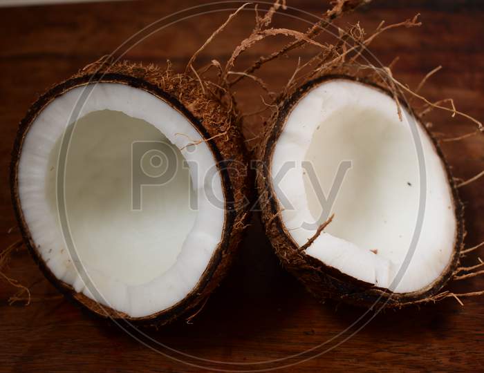 Pieces Of Coconut With Brown Background