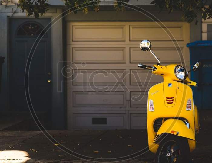 Yellow scooter in dark background