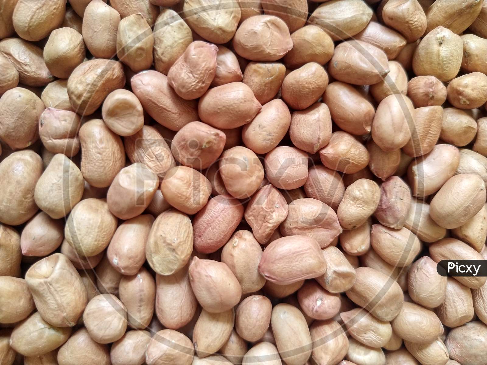 Raw dried peanuts background.