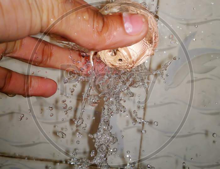 Water splashing over the glass ball.