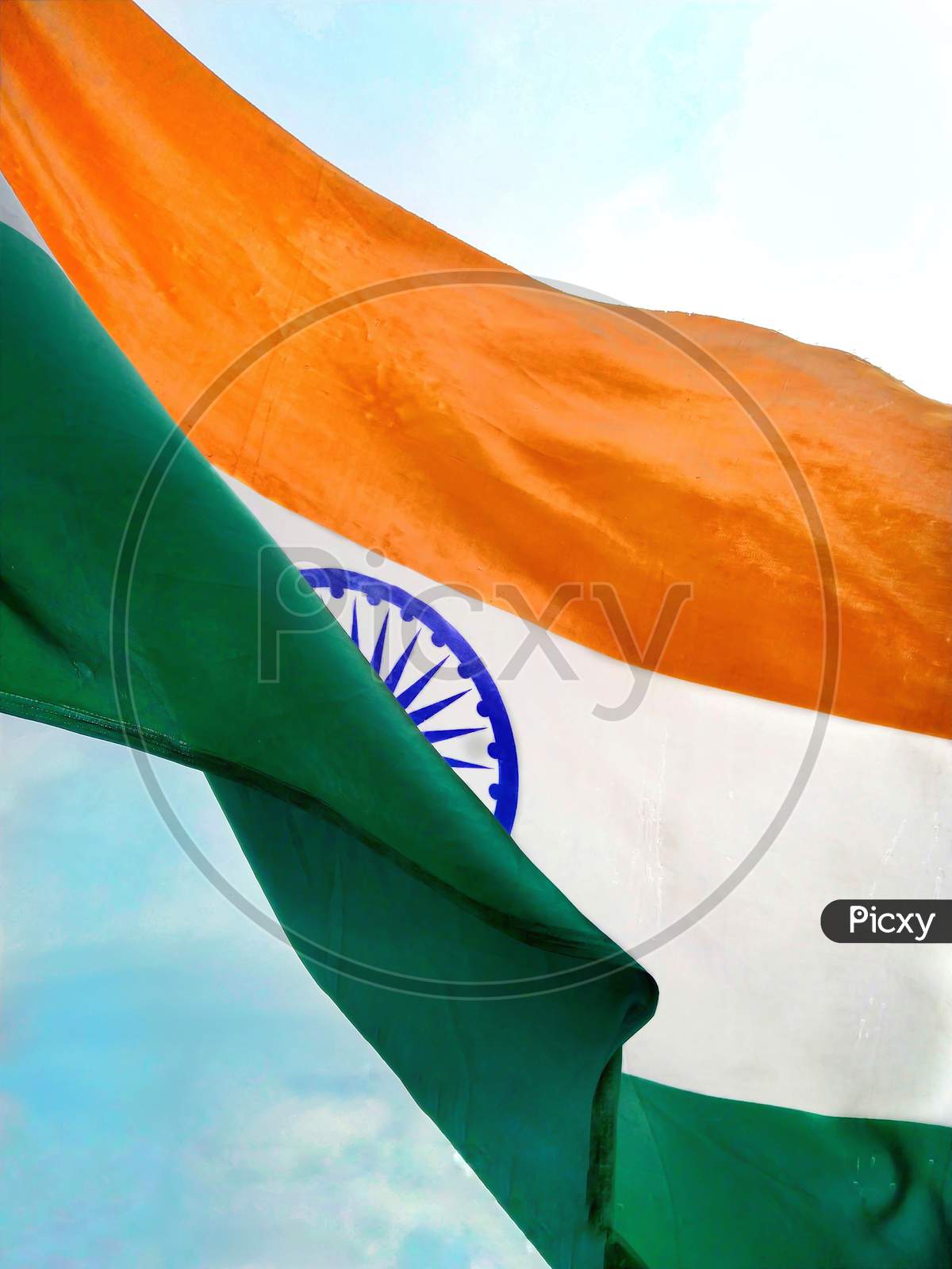 Indian flag waving against beautiful blue sky.