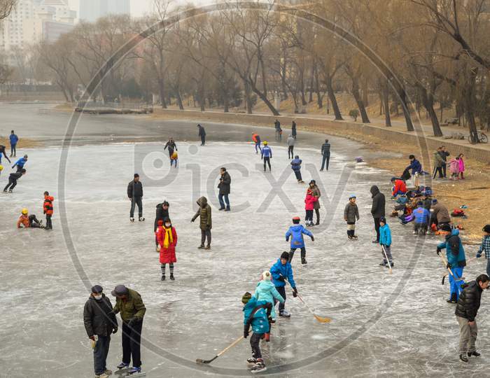 People Ice Skating On The Frozen Liangma River Canal In Beijing, China