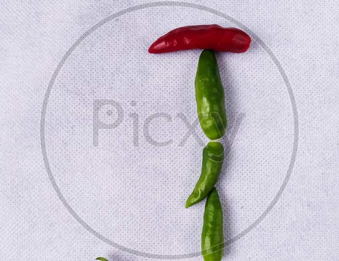 Red And Green Chilli In "J" Shape In A White Background