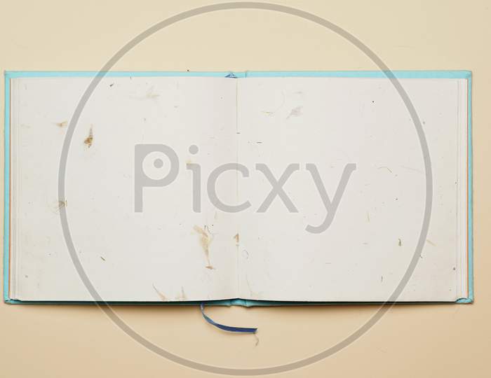 Top View Of Open Notebook With Recycled Flower Sheets On Flat Color Background. Flat Lay