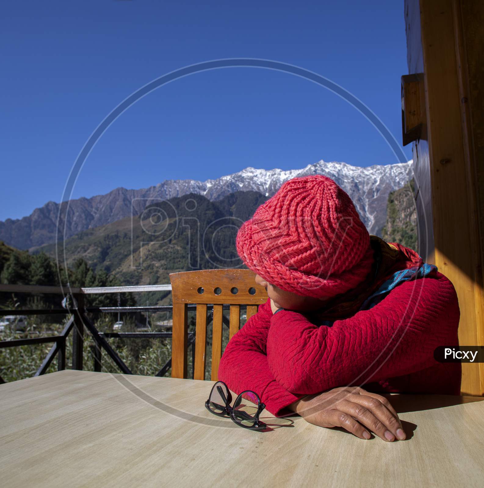 A Beautiful Young Lady With A Red Sweater Enjoying Nature On A Balcony Of A Restaurant On The Mountain Himalayas