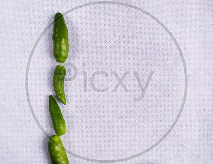 Green Chilli In "L" Shape In A White Background