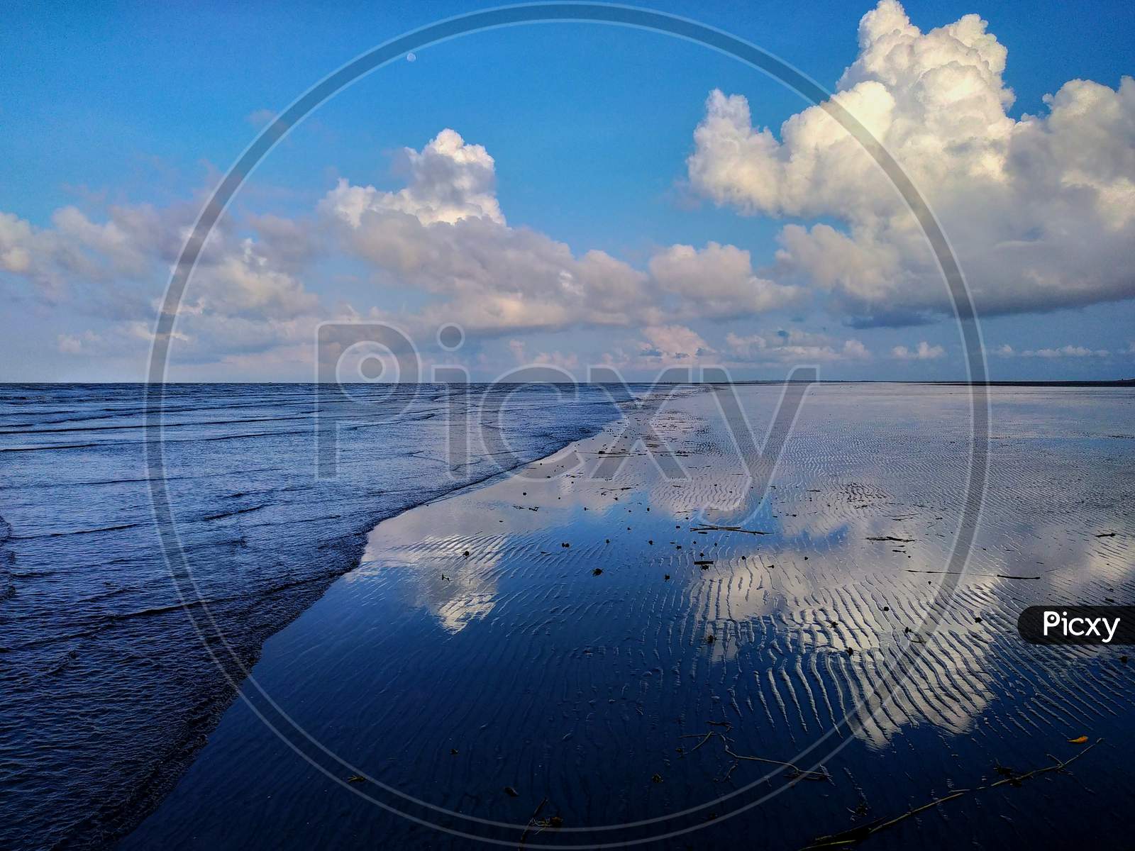 Sky reflection in sea beach at Bakkhali