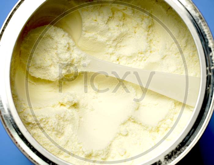 Close Up View Of Scoop Of Powdered Baby Milk. Flat Lay