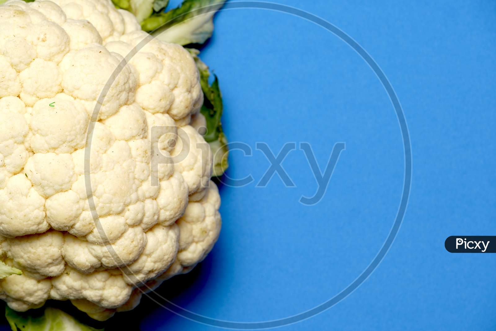 Cauliflower Top View On Blue Background. Vegetarian Or Vegan Concept. Flat Lay
