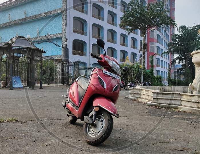 Red Scooter and magnificent hotel