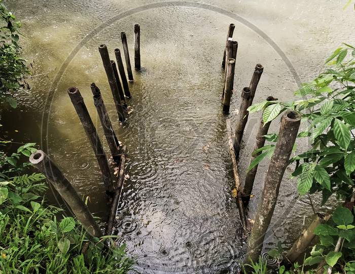 A Pond Ghat In A Village Made With Bamboo Pile