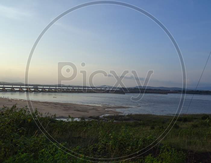 Sunset landscape view of Naraj Barrage with flood gates on Mahanadi river when human meets nature