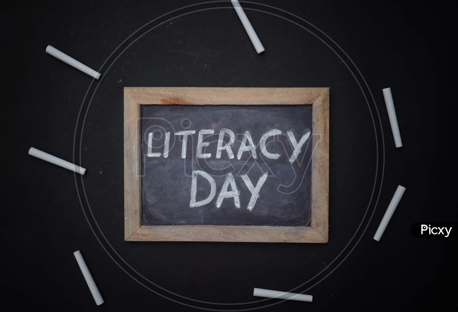 Literacy Day Written On Chalkboard With White Chalk Isolated On Black Background