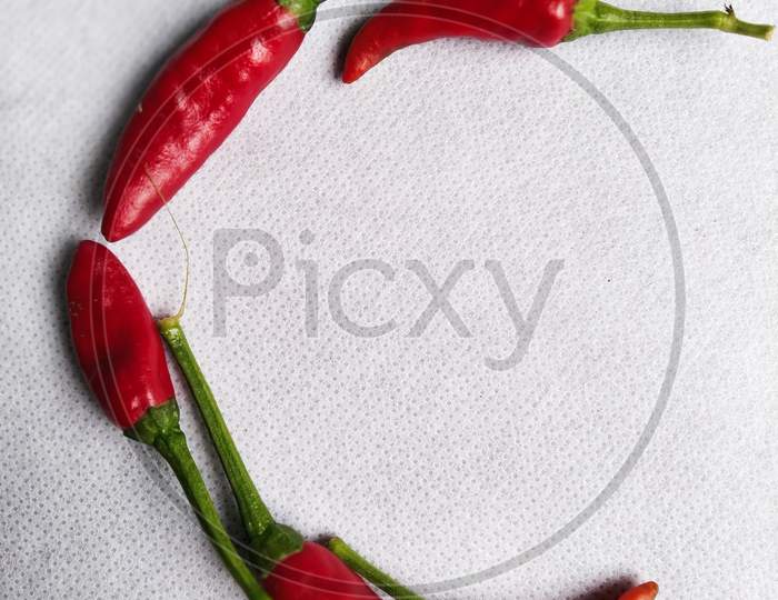 Red Chilli In a "C" Shape In A White Background