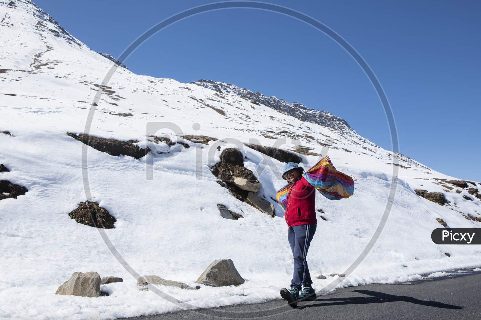 A Beautiful Young Lady With A Red Sweater And Sunglass Enjoying Nature On A Snow Covered High Altitude Pass On Himalaya