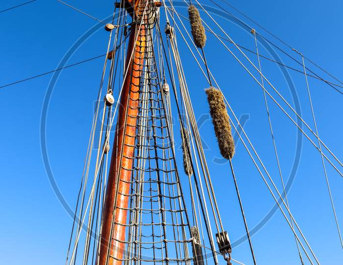 Sailing Ship Mast Against The Blue Sky On Some Sailing Boats With Rigging Details.