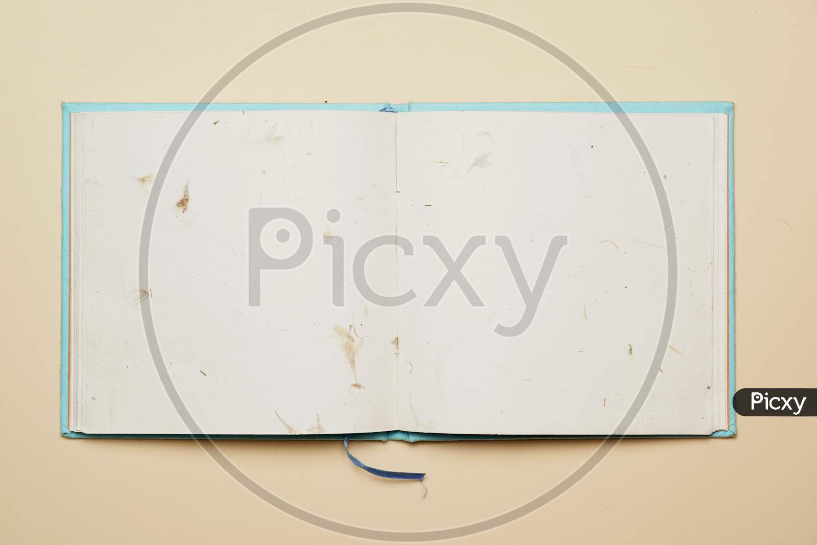 Top View Of Open Notebook With Recycled Flower Sheets On Flat Color Background. Flat Lay