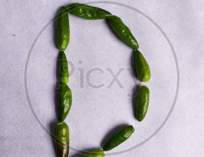 Green Chilli In "D" Shape In A White Background