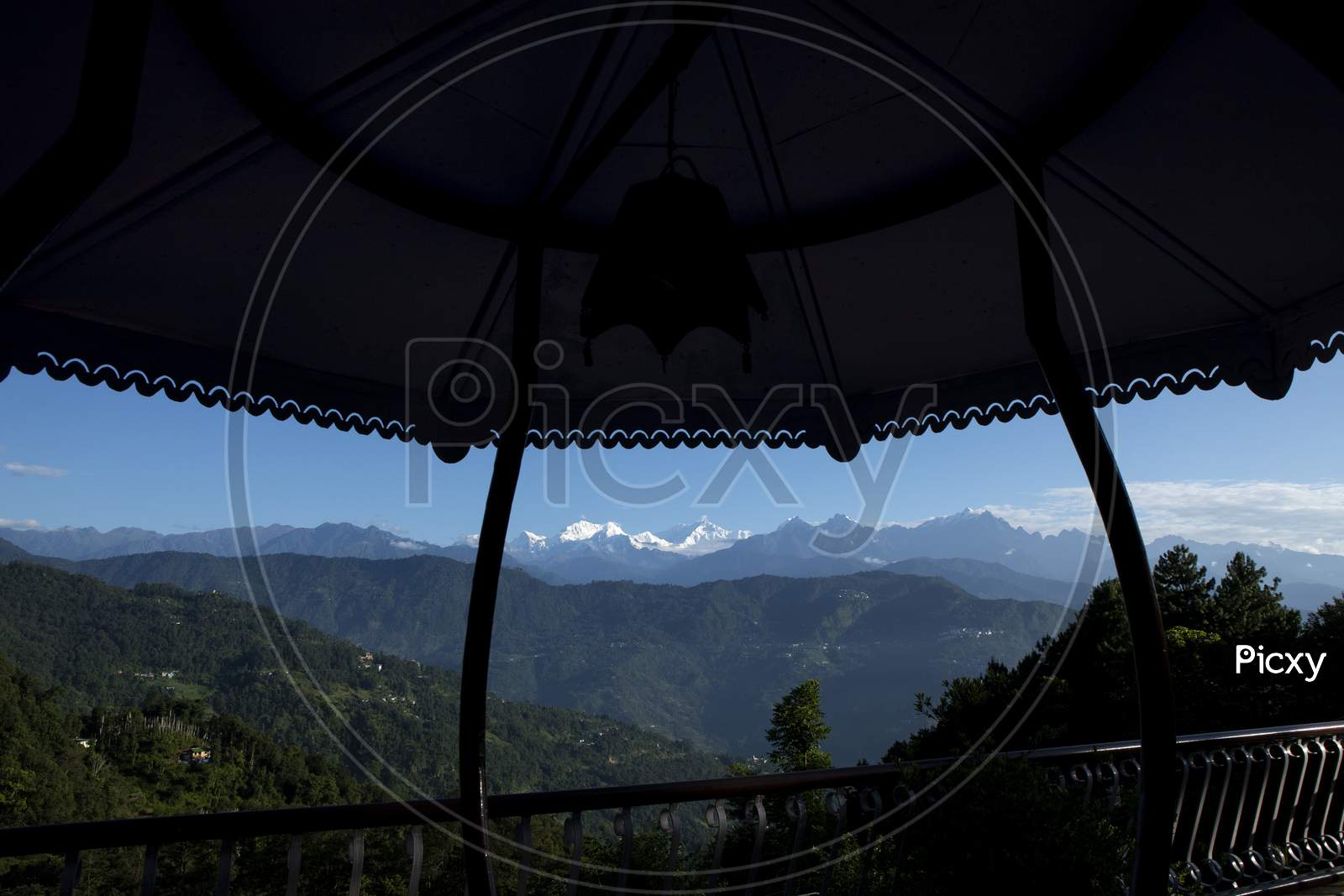 The Mighty Kanchanjunga With Other Snow Peaks At The Background Of A Small Village On The Slope Of Mountains On The Himalaya From The Balcony Of A Tourist Cottage In Sikkim