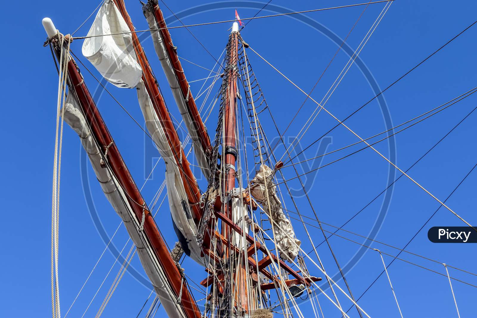 Sailing Ship Mast Against The Blue Sky On Some Sailing Boats With Rigging Details.