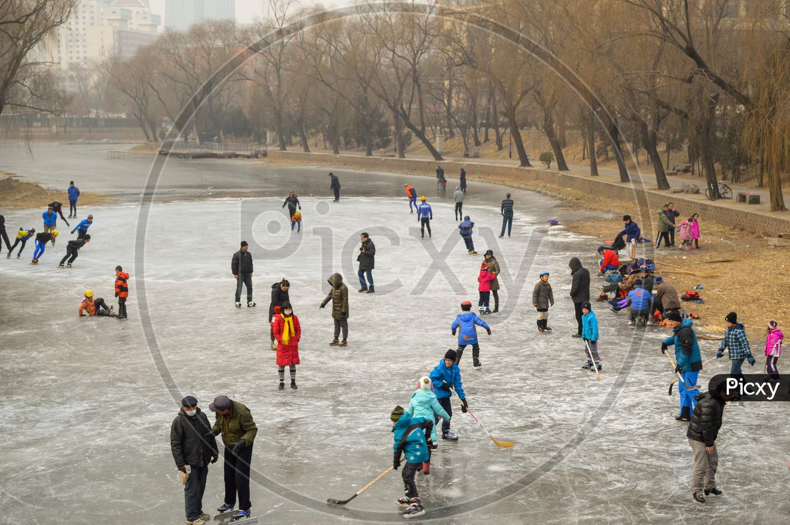 People Ice Skating On The Frozen Liangma River Canal In Beijing, China