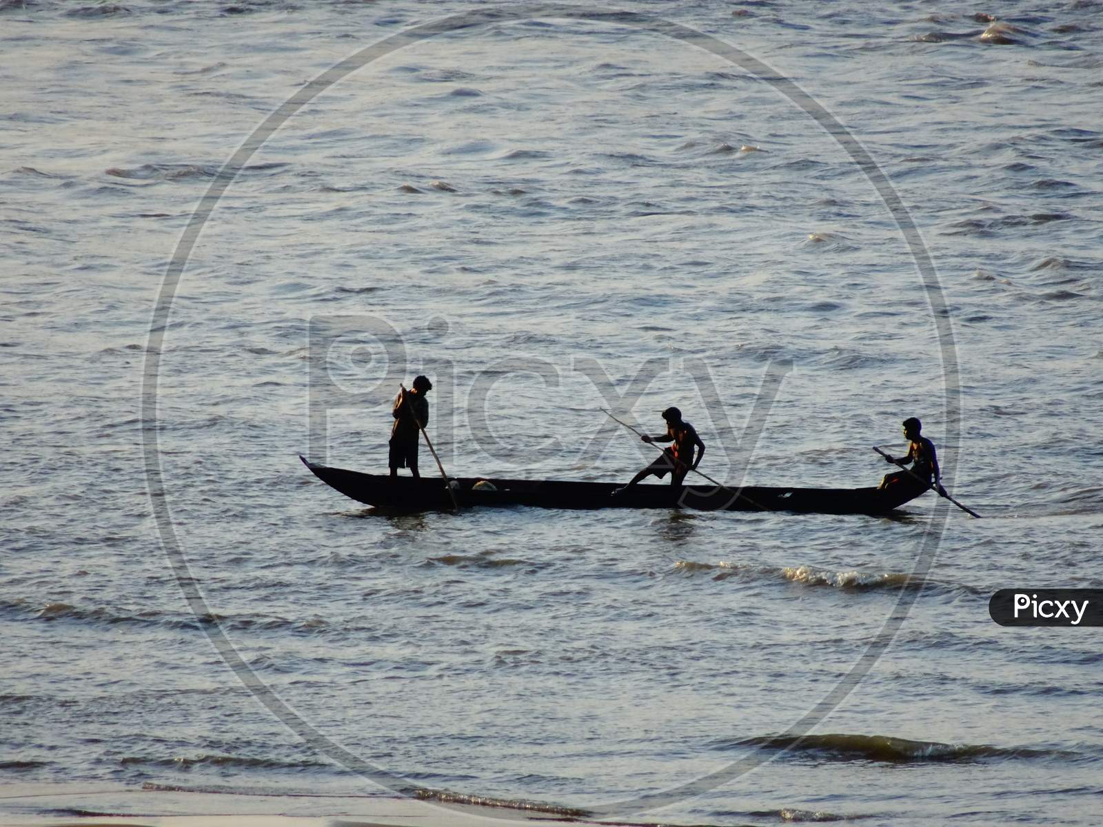 Fisherman fishing on boat in the Mahanadi river at Naraj, Cuttack