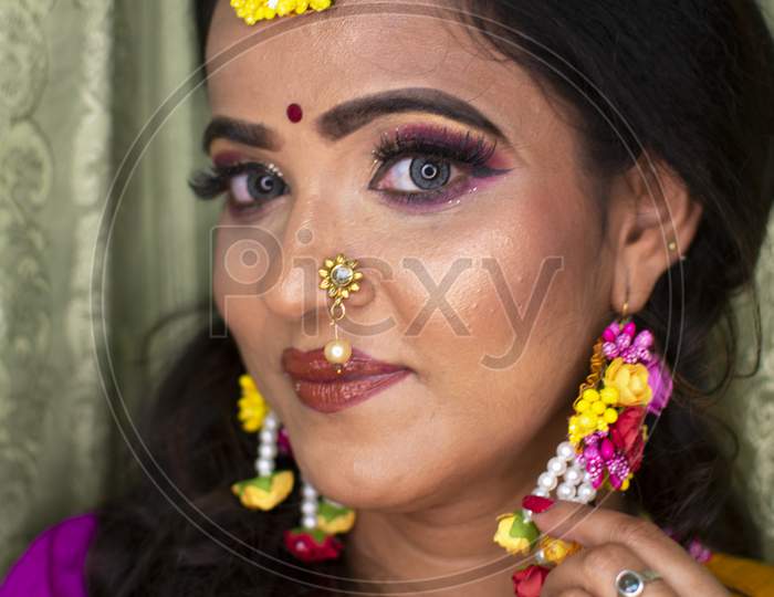 An Indian Woman Wearing Traditional Dress And Flower Ornaments