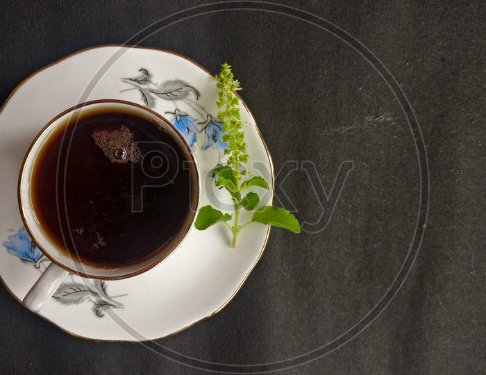 Herbal tea with basil in the black paper