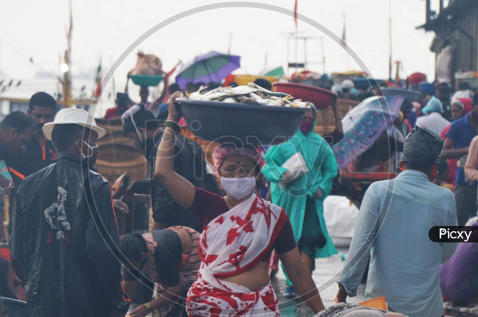 A fisherwoman wearing a protective mask is seen at a fish market amidst the spread of the coronavirus disease (COVID-19) in Mumbai, India on September 7, 2020.