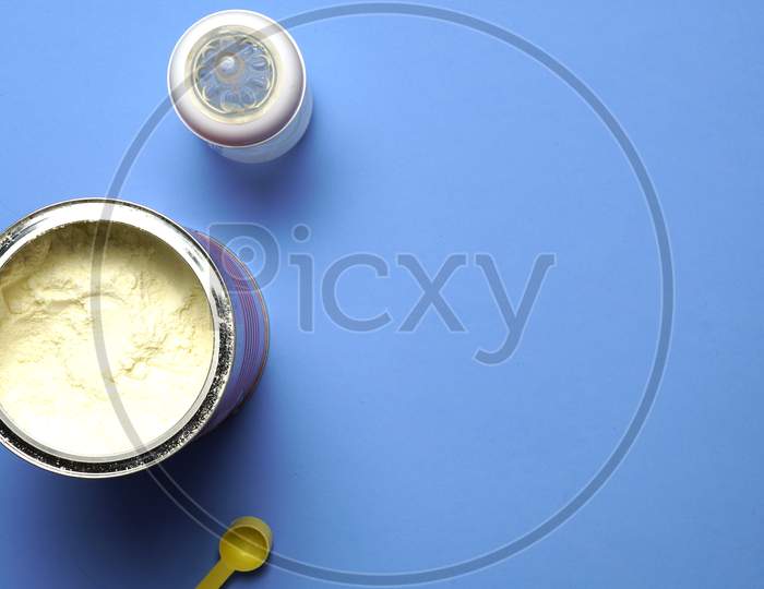 Top View Baby Milk Powder Scoop And Bottle. Baby Feeding Concept. Flat Lay