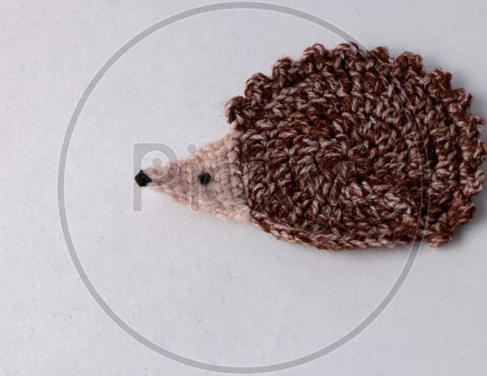 Cute Brown Woollen Hedgehog , Handmade Craft Of Crochet, Isolated On White