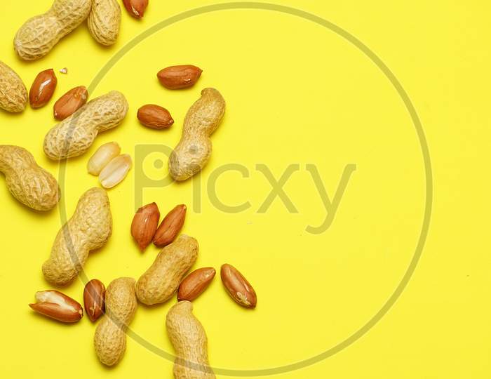 Peanuts On Yellow Background Peeled And Unpeeled. Flat Lay