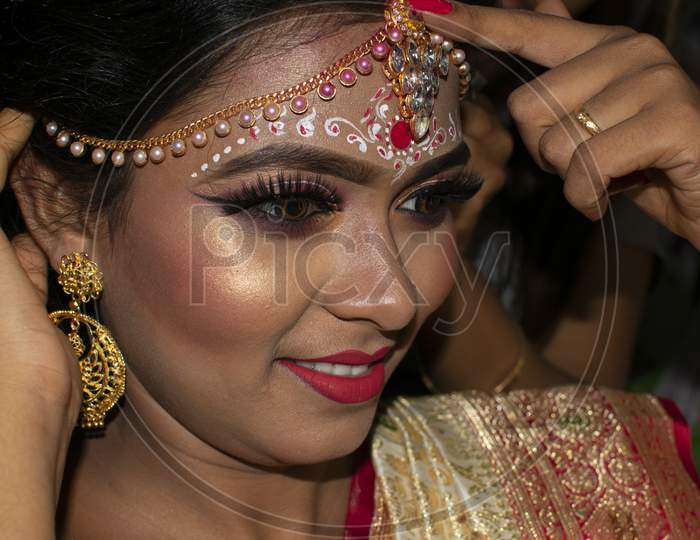 A Girl In Her Marriage Day Adjusting Her Jewelry