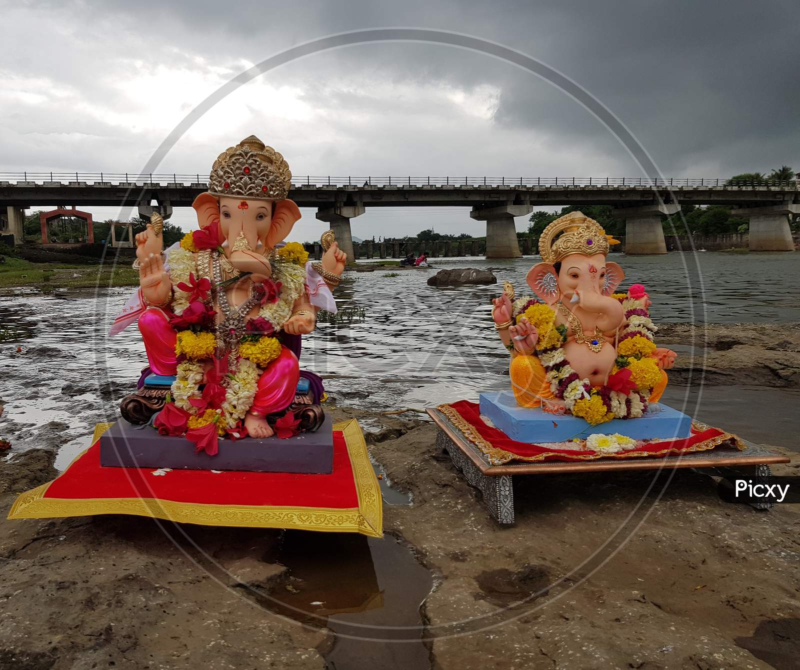 Two Ganpati Idols On The Rock Near The River Side Were Brought For Visarjan.