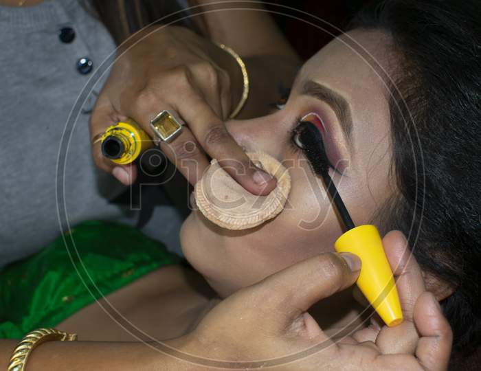 An Indian Woman Getting Bridal Makeup
