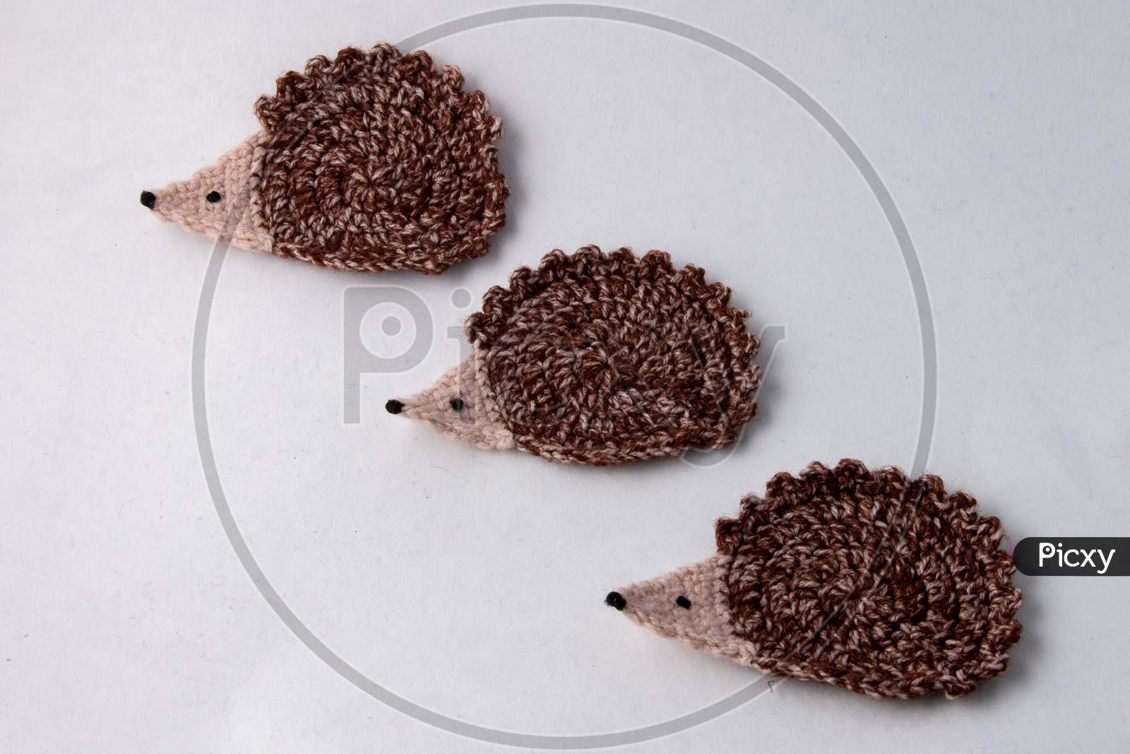 3 Cute Brown Woollen Hedgehog , Handmade Craft Of Crochet, Isolated On White