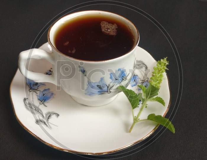 Red tea in a white cup and plate