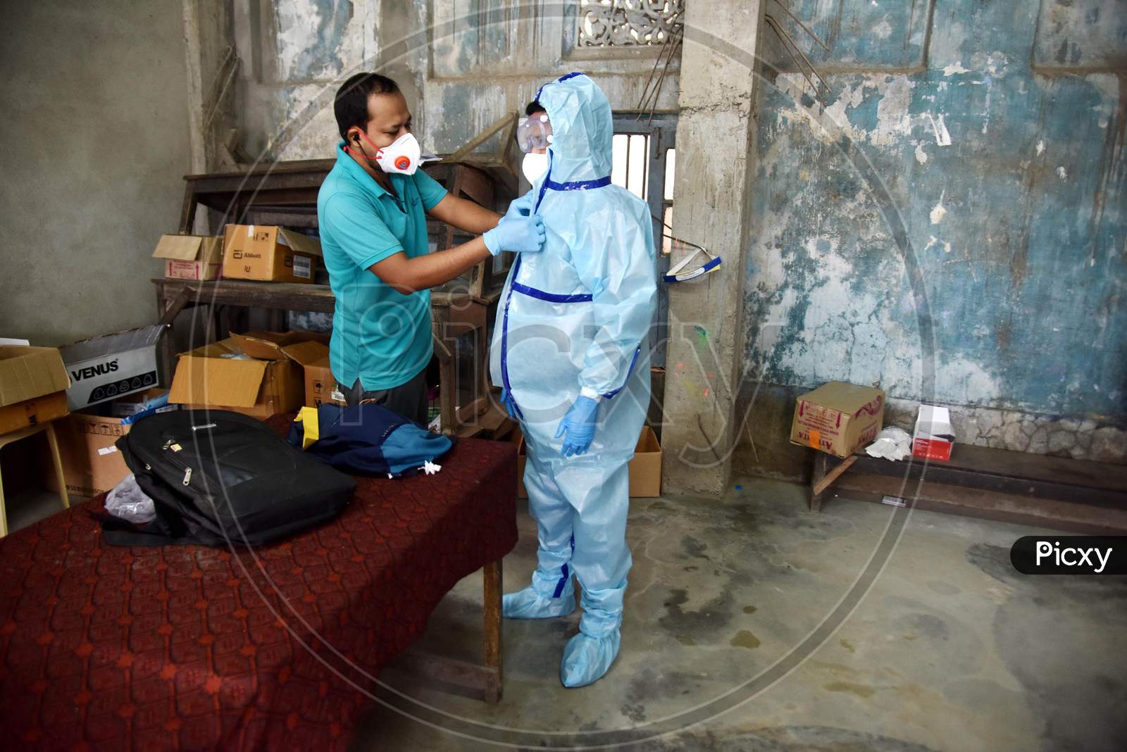 An Indian Health worker wears a Personal Protective Equipment (PPE) before taking swab samples of people suspected for coronavirus COVID-19 Rapid Antigen detection testing in Nagaon District of Assam on Sep 08,2020